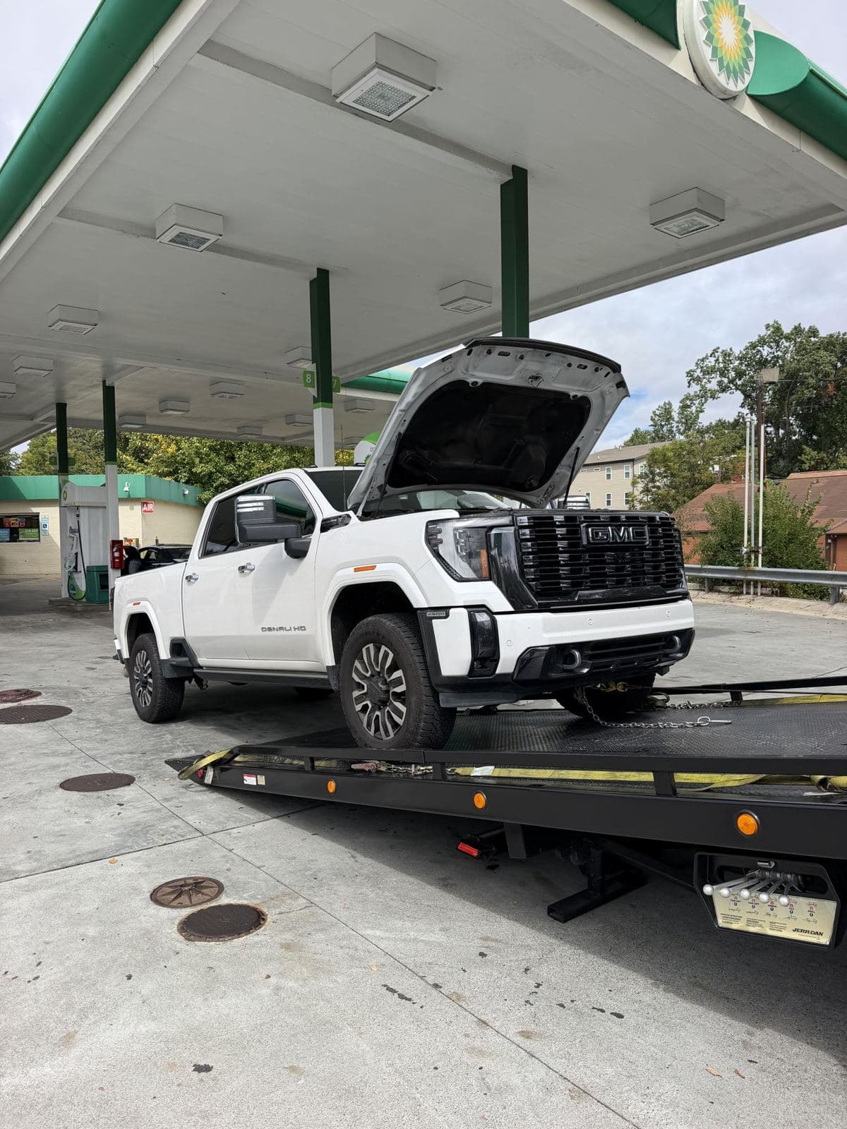 Flatbed tow truck loading a pickup for transport