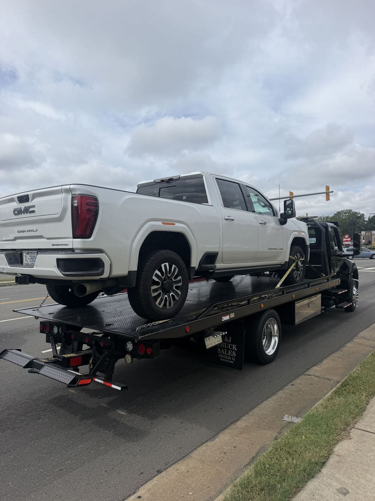 Durham towing: pickup secured on Ortma Towing's flatbed tow truck