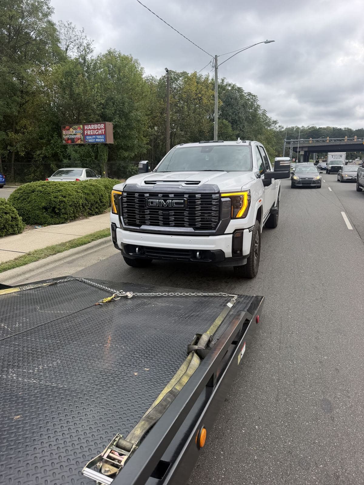 Pickup lined up behind Ortma Towing's lowered rollback bed
