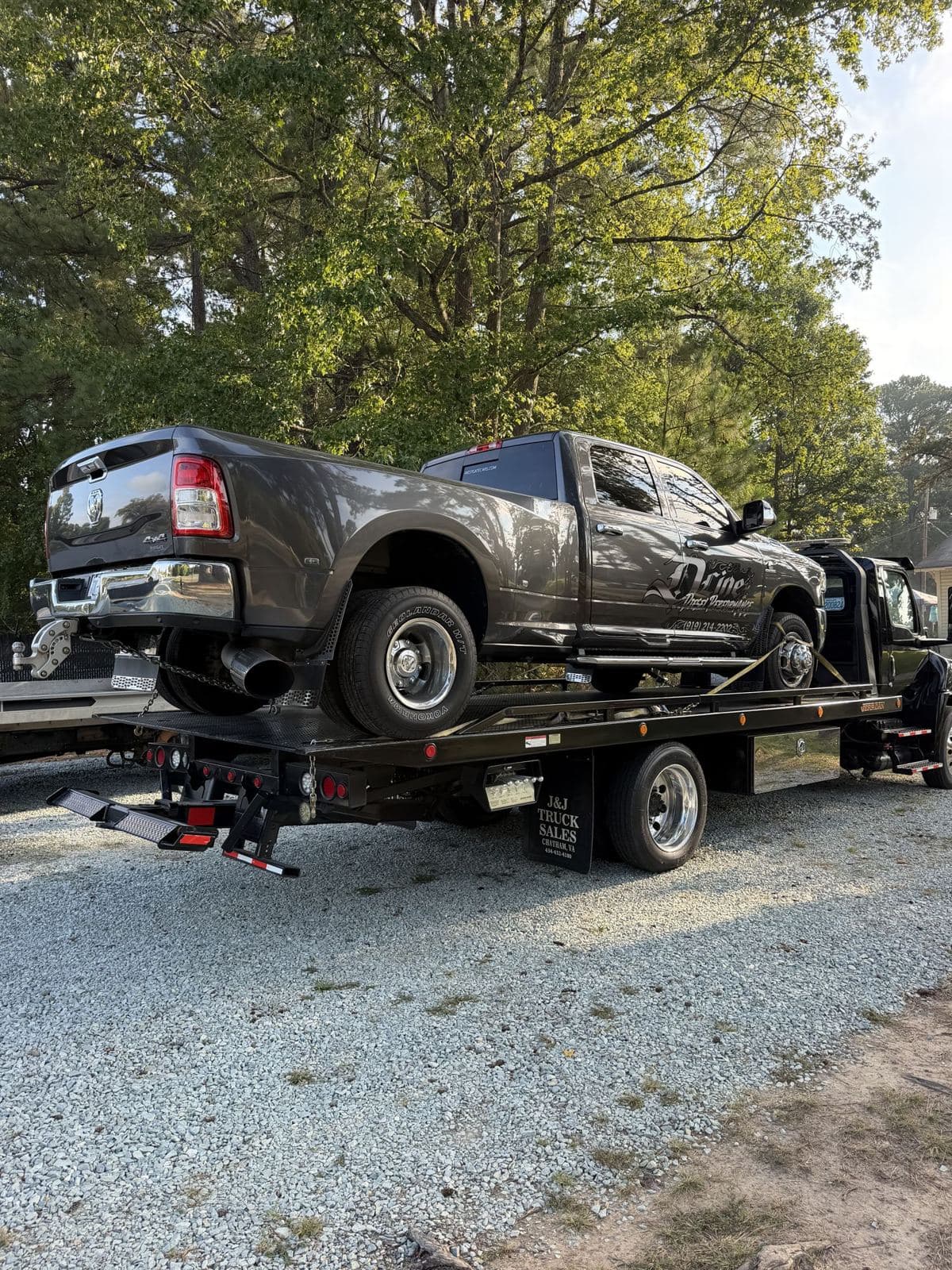 Pickup secured on a flatbed for transport